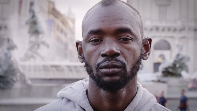Sad depressed young black man alone in the street
