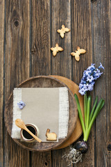 Close-up of a cute butterfly  cookies  and hyacinth flower on a vintage wooden background. Spring and Easter concept, top view, space for text.