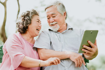 Happy senior couple using tablet