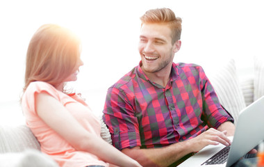 closeup of a smiling young couple with laptop