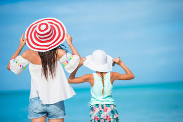 Beautiful mother and daughter on Caribbean beach. Family beach vacation
