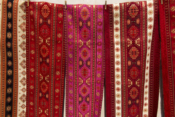 colorful fabrics and other folk products at a roadside stall with traditional Armenian colors and patterns