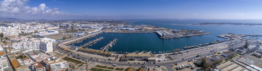 Aerial daytime view of Olhao fishing dock and seascape, waterfront to Ria Formosa natural park. Algarve.