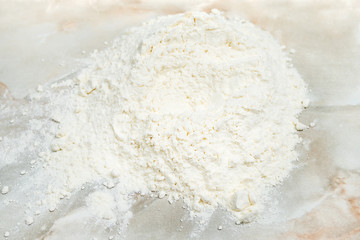 Pile of white wheat flour on a marble table