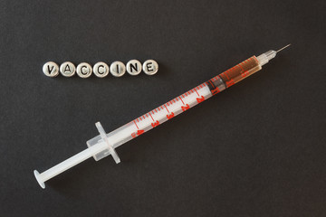  syringe with liquid, inscription vaccine