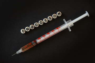 syringe with a liquid with an inscription injection