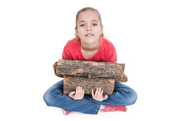 Girl sitting with legs crossed and holding firewood, looking up at camera isolated on white background