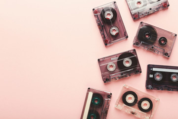 Vintage audio cassettes border on pink background