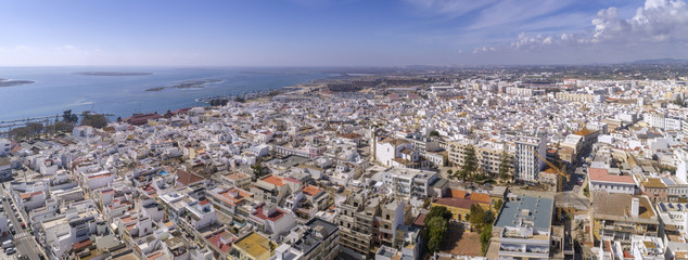 Aerial daytime view of Olhao downtown, waterfront to Ria Formosa natural park. Algarve.