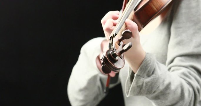 classical musician playing baroque violin on a black background - hands closeup live action concept