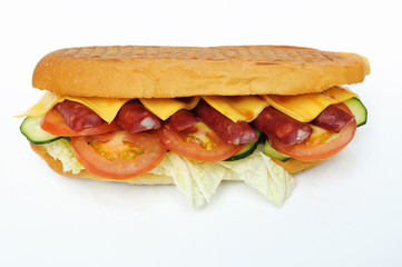 sandwich with sausage, tomato, cucumber, cheese and lettuce on a white background