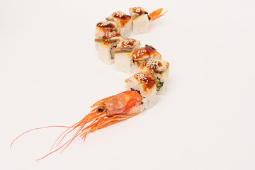 rolls in the form of a dragon with a head of shrimp on a white background