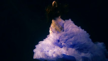 princess is sinking in ocean water in a black background, cute child girl is wearing quinceanera dress