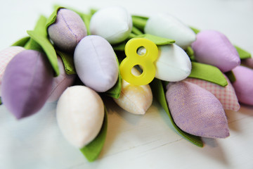 Greeting card for March 8 Women. A bouquet of tulips on a wooden background with the figure 8. International Women's Day