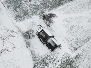 Aerial view of farm building in snow covered landscape in Switzerland