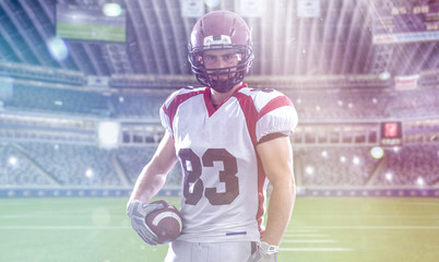 Fototapeta premium American Football Player isolated on big modern stadium field