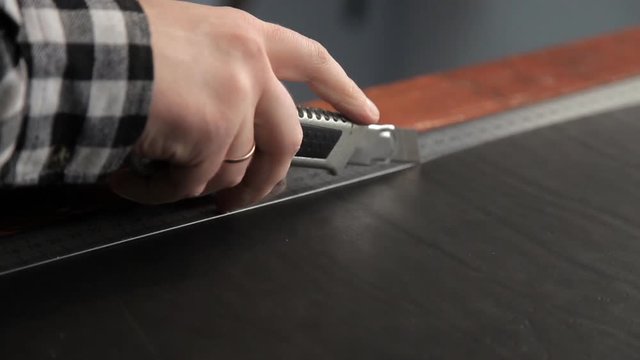 A master from a leather rudder cuts billets to make a belt. Procedure for the manufacture of leather belts.
