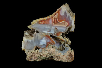 Cross section of the agate. Multicolored silica bands colored with metal oxides are visible....