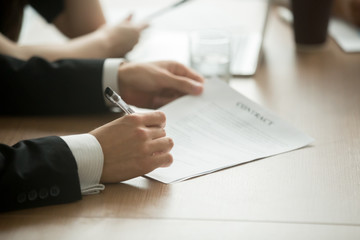 Businessman in suit signing business contract making deal, investor or executive putting signature on commercial paper, filling legal document in lawyers office, taking loan insurance, close up view