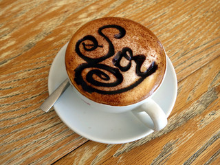 A cappuccino made with soy milk in a cup an saucer ready for drinking        