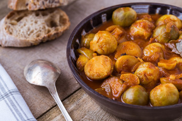 Roasted fresh brussels sprouts with in homemade ceramic bowl.