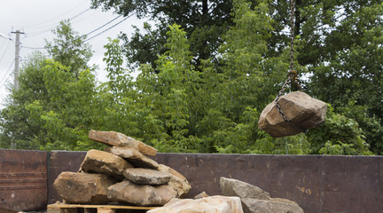 Delivery and unloading of building stone by truck with a crane