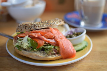 Healthy bagel stuffed with salad and smoked salmon