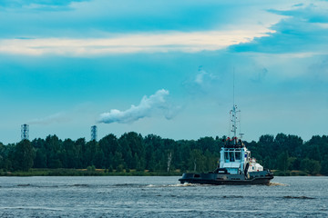 Black tug ship underway