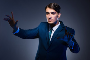 Businessman pressing virtual buttons on gray background