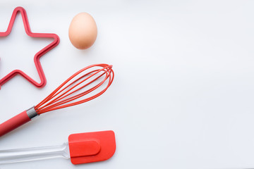 Items for scrambled eggs and omelets, desserts, bakery. Egg, corolla, silicone spatula, silicone mold. The concept of cooking breakfast. Flat lay, copy space, top view.