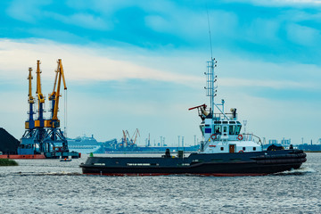 Black tug ship underway