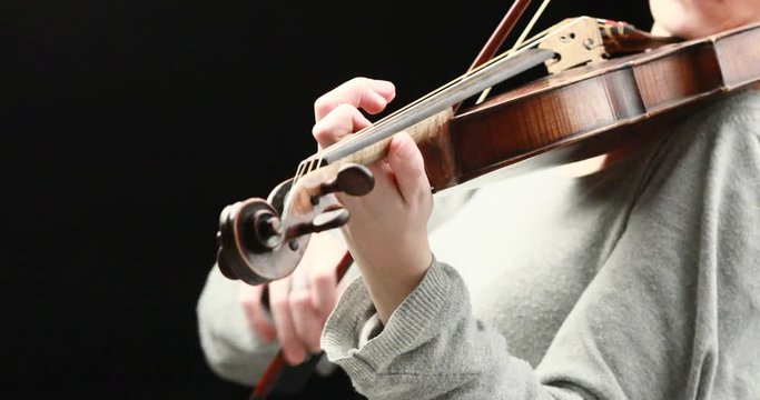classical musician playing baroque violin on a black background - hands closeup live action concept