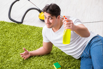 Young husband man cleaning floor at home