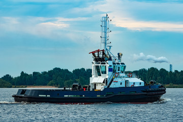 Black tug ship underway