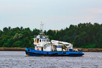 Blue tug ship underway