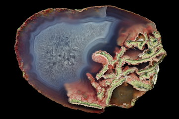 A cross-section of agate. Agate with quartz-agate fill. Multicolored silica bands colored with...