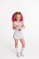 Colored wavy hair. Ombre. Little modern hipster girl in fashion clothes, Selfie. Studio. Isolated on white