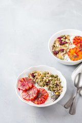 Healthy morning breakfast with granola yogurt blood oranges