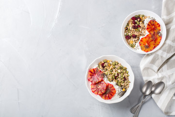 Healthy morning breakfast with granola yogurt blood oranges