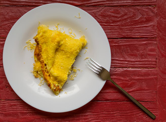 Omelette with grated cheese on a plate.