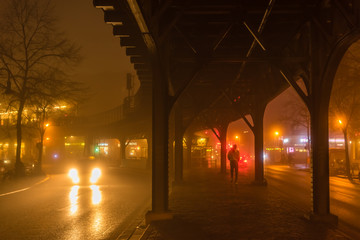 the guy with a yellow jacket under a elevated railway © Andy Hoech