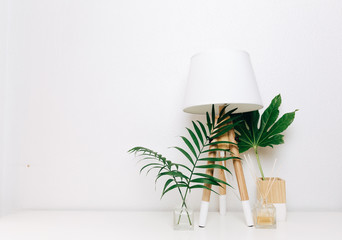 Hipster Scandinavian style room interior. Nordic lamp with tropical leaves. Minimalist style