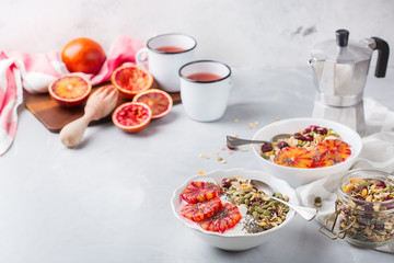Healthy morning breakfast with granola yogurt blood oranges