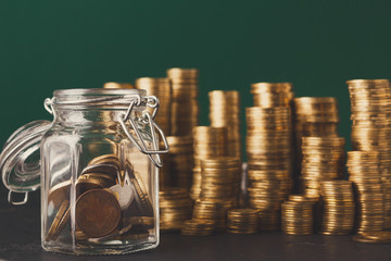 Coins in glass jar for money saving, copy space