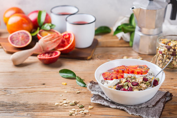 Healthy morning breakfast with granola yogurt blood oranges