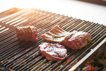 Steak and rib are cooking on grill. Pork ribs and steak on hot grill. Restaurant kitchen, culinary.