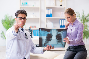 Fototapeta premium Doctor examining x-ray images of patient
