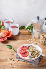 Healthy morning breakfast with granola yogurt blood oranges