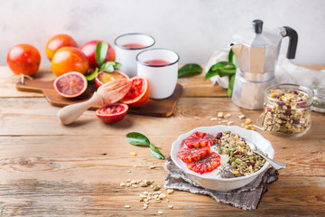 Healthy morning breakfast with granola yogurt blood oranges