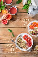 Healthy morning breakfast with granola yogurt blood oranges